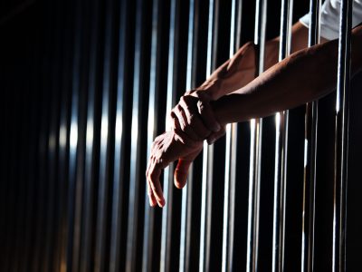 close up of hand in jail background.